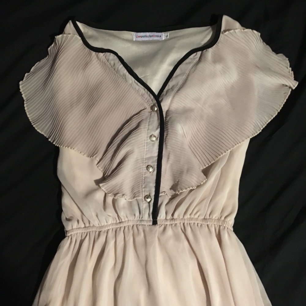 Cream colored with black trim ruffle top dress